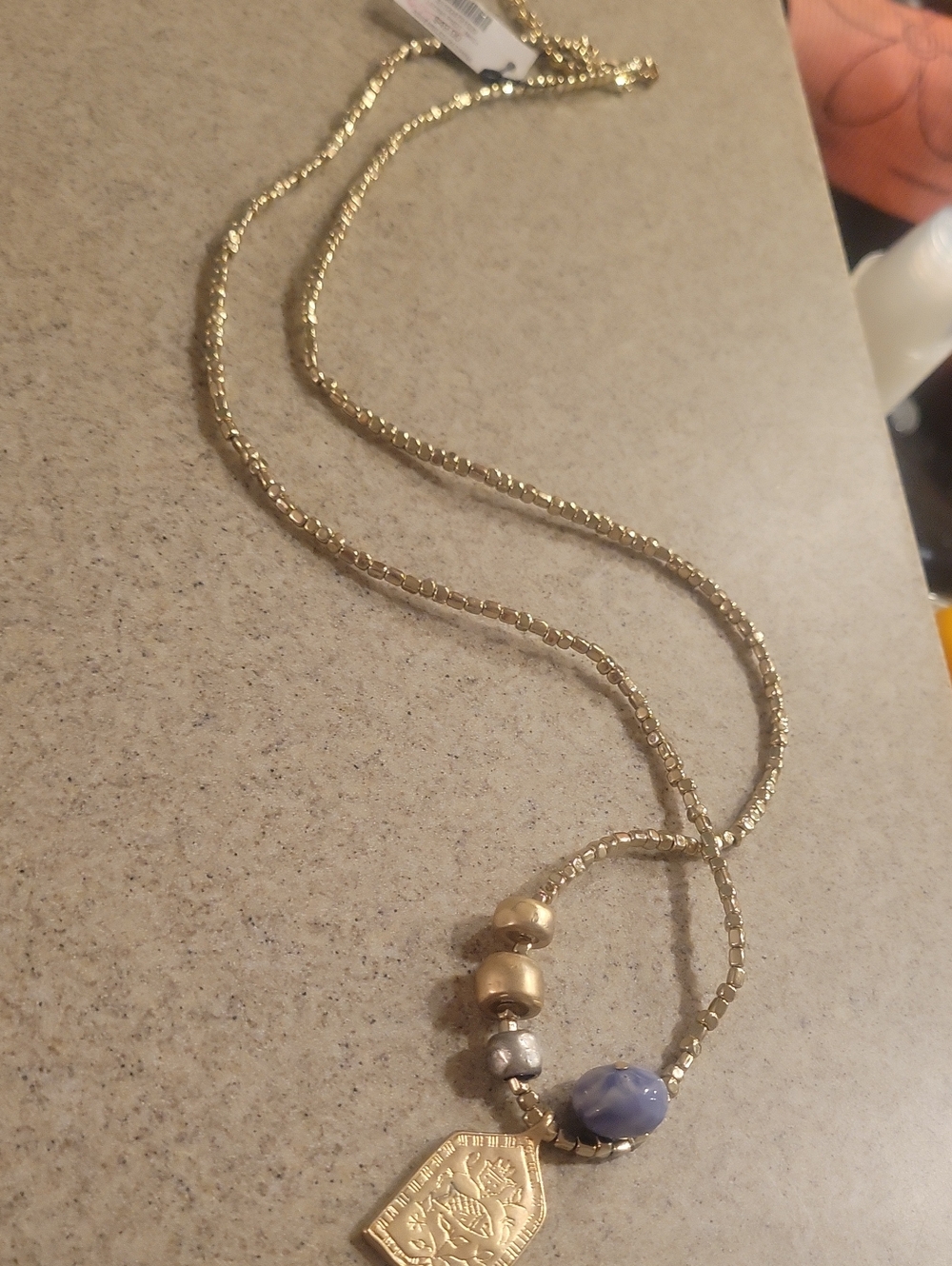 Chico's Gold Beaded Necklace with Blue Accent Stone and Coin Charm